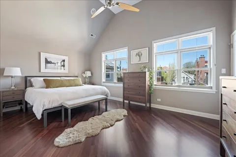 a spacious bedroom with a bed dresser and a window