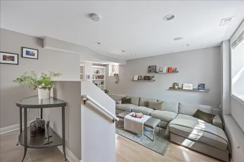 a living room with furniture and a potted plant