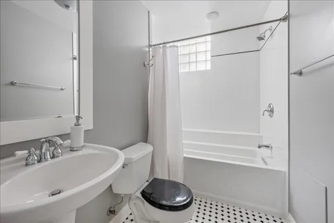 a bathroom with a sink a toilet and a bathtub