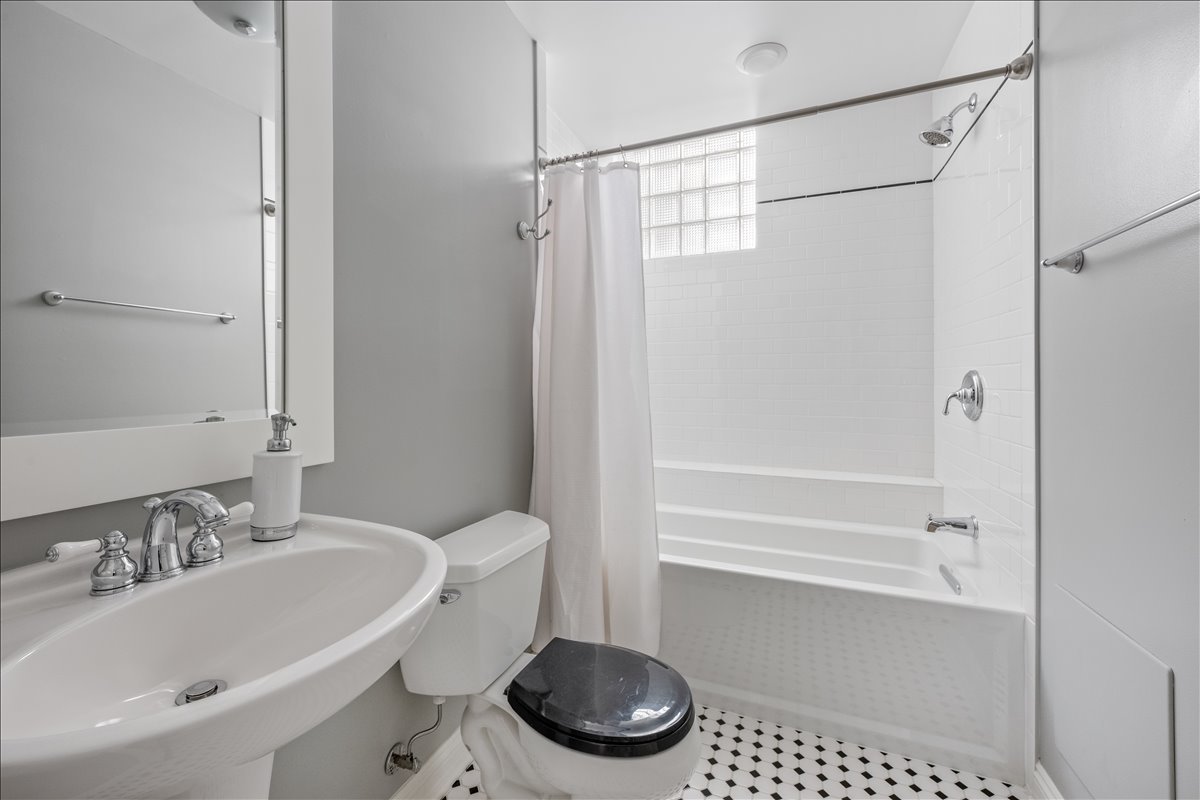 1332 West School Street Chicago, IL 60657 - Photo 35 of 45 a bathroom with a sink a toilet and a bathtub