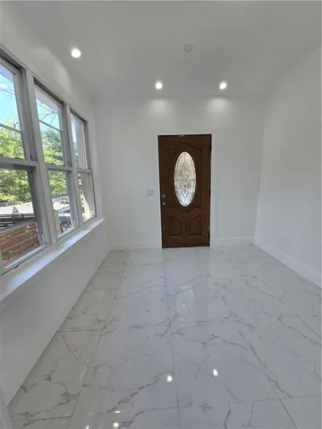 a view of a room with wooden floor and windows