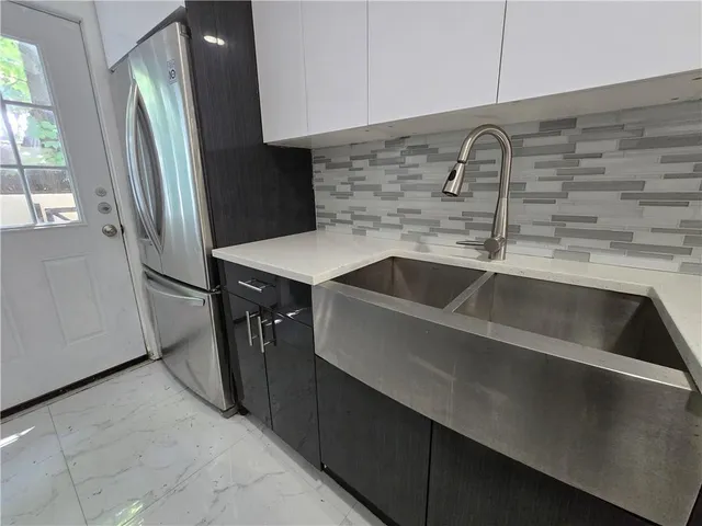 a kitchen with a sink and refrigerator