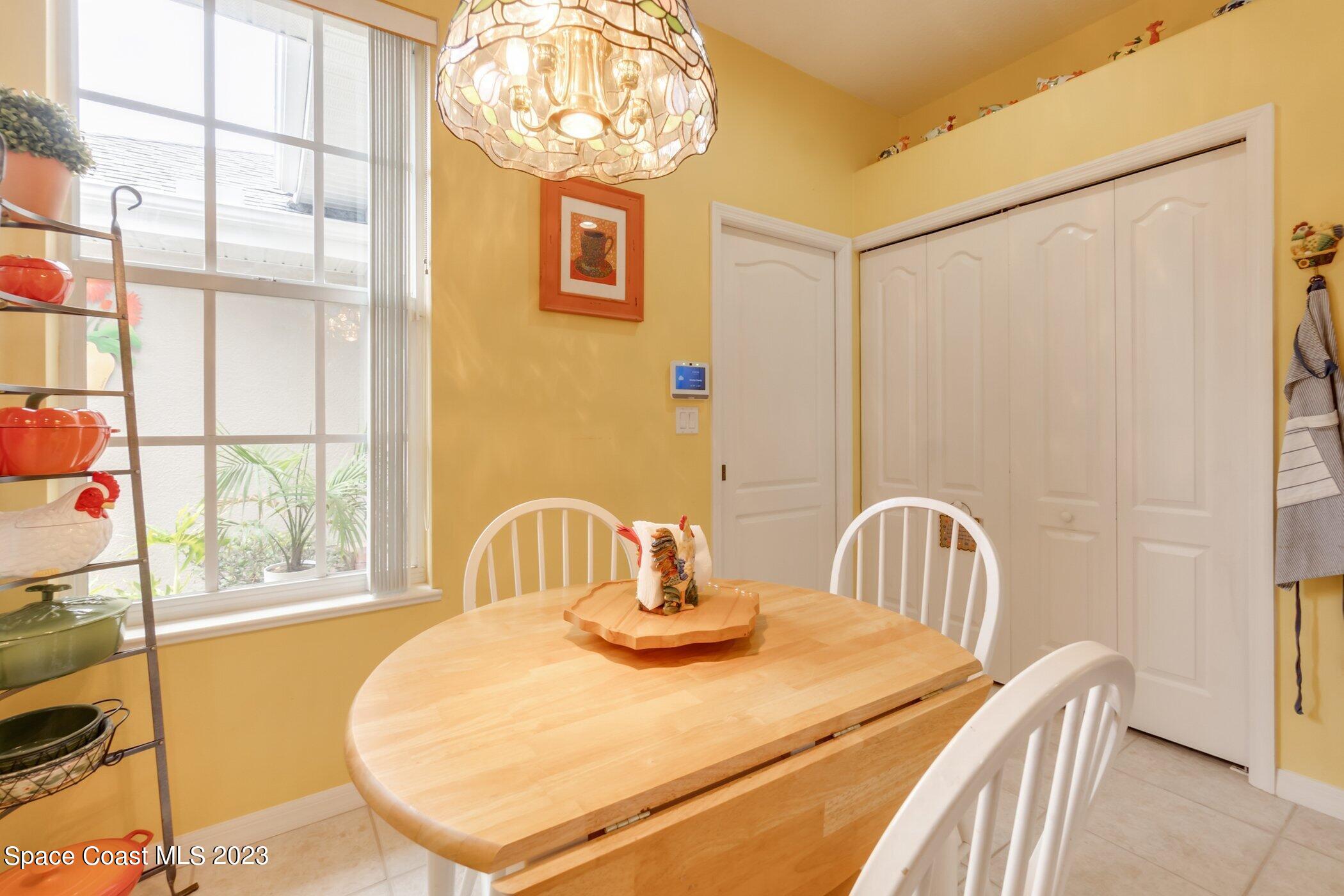 4370 Aberdeen Circle Rockledge, FL 32955 - Photo 11 of 58 a dining room with a window and chandelier
