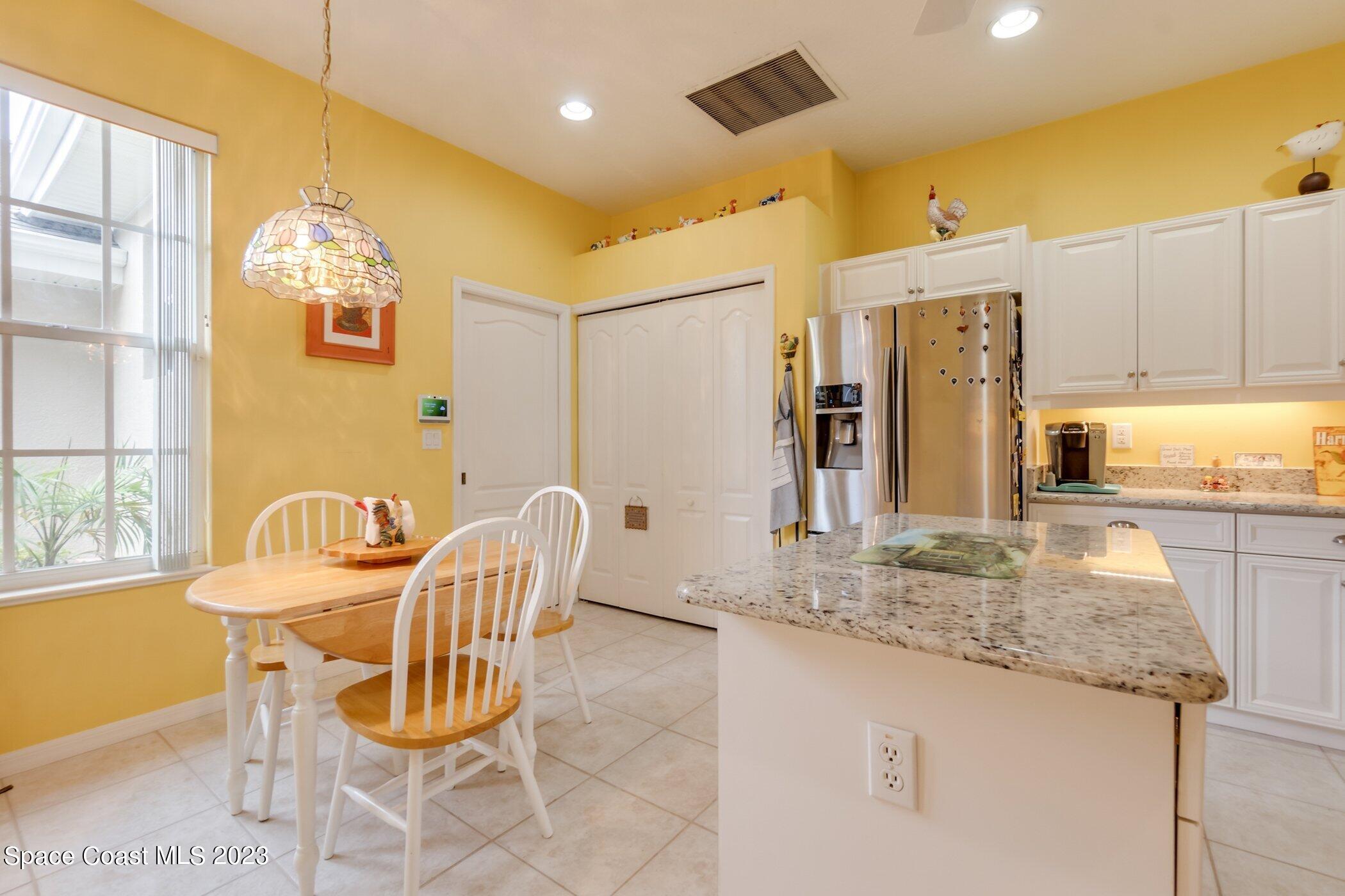 4370 Aberdeen Circle Rockledge, FL 32955 - Photo 12 of 58 a dining room with furniture and chandelier