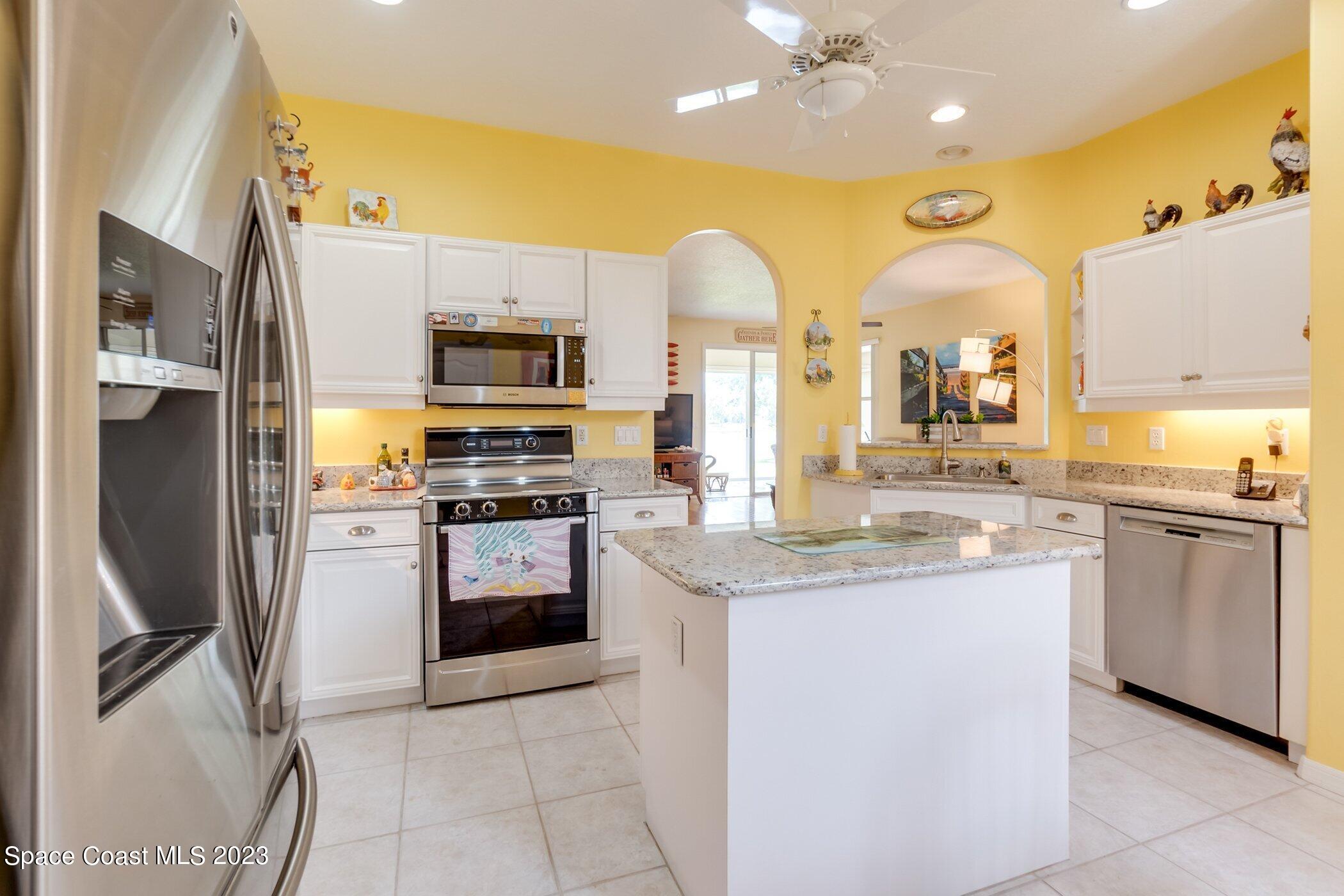 4370 Aberdeen Circle Rockledge, FL 32955 - Photo 14 of 58 a kitchen with a sink stove and refrigerator