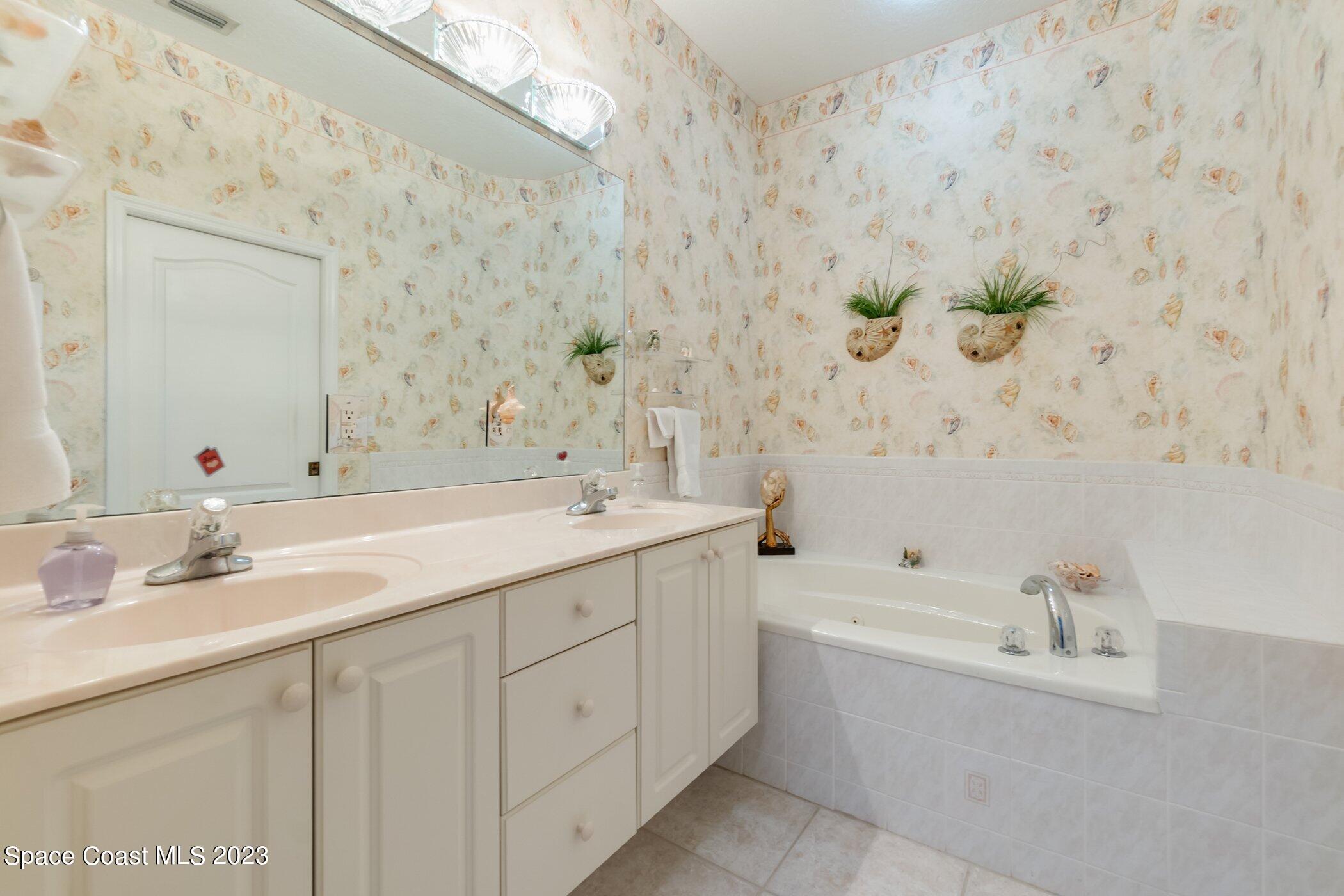 4370 Aberdeen Circle Rockledge, FL 32955 - Photo 21 of 58 a bathroom with a bathtub sink and mirror