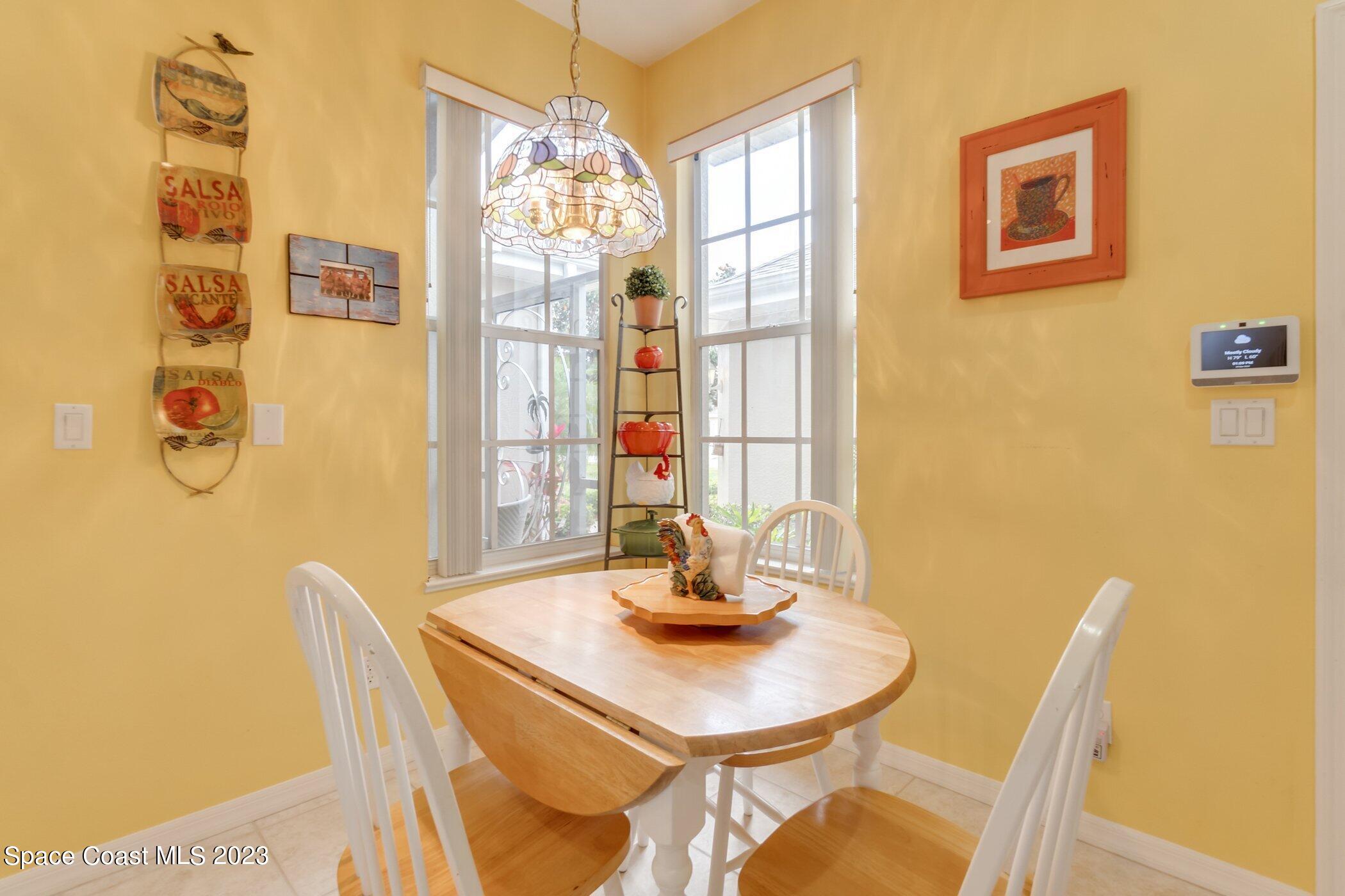 4370 Aberdeen Circle Rockledge, FL 32955 - Photo 29 of 58 a view of a dining room with furniture and chandelier