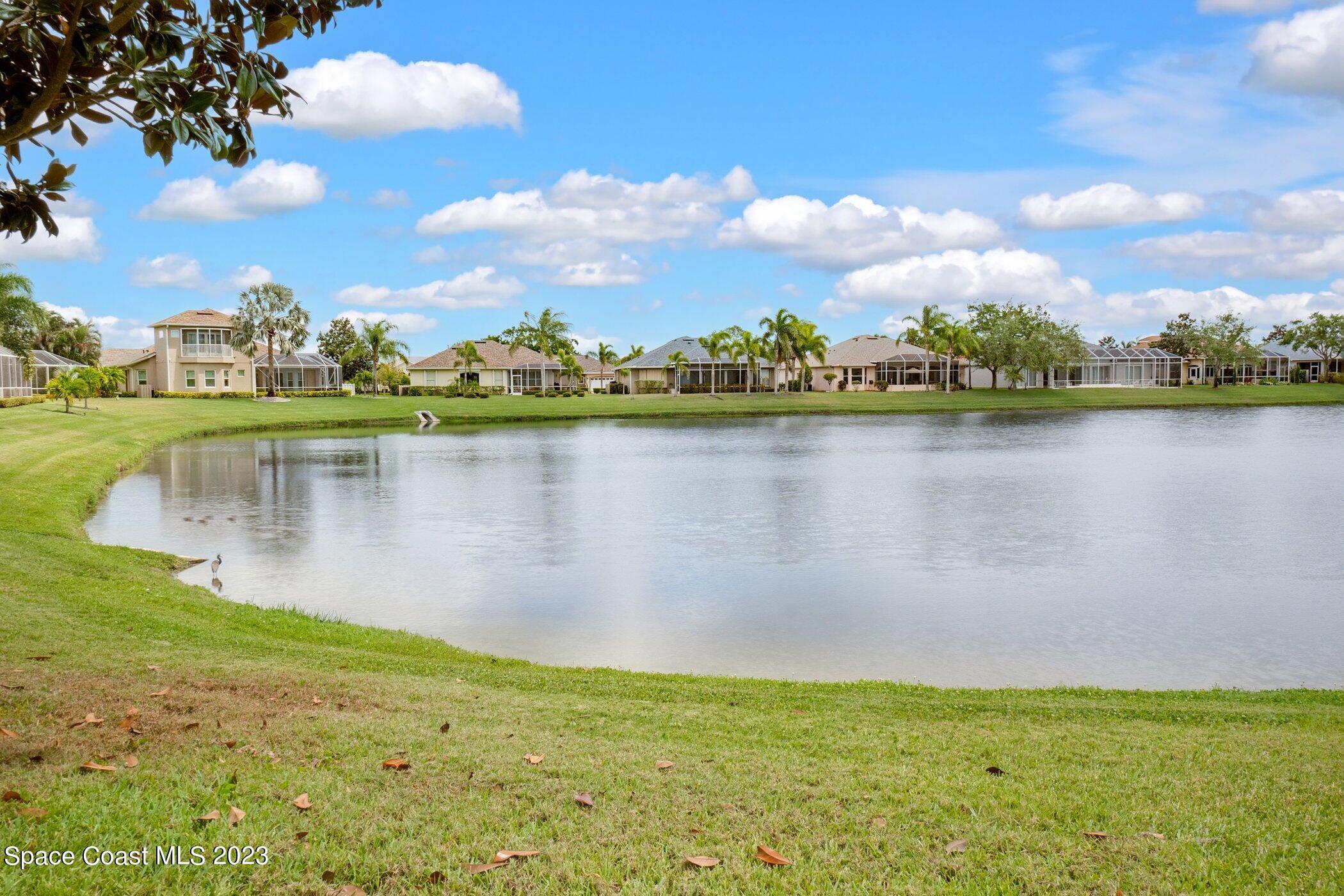 4370 Aberdeen Circle Rockledge, FL 32955 - Photo 31 of 58 a view of a lake with houses in the background