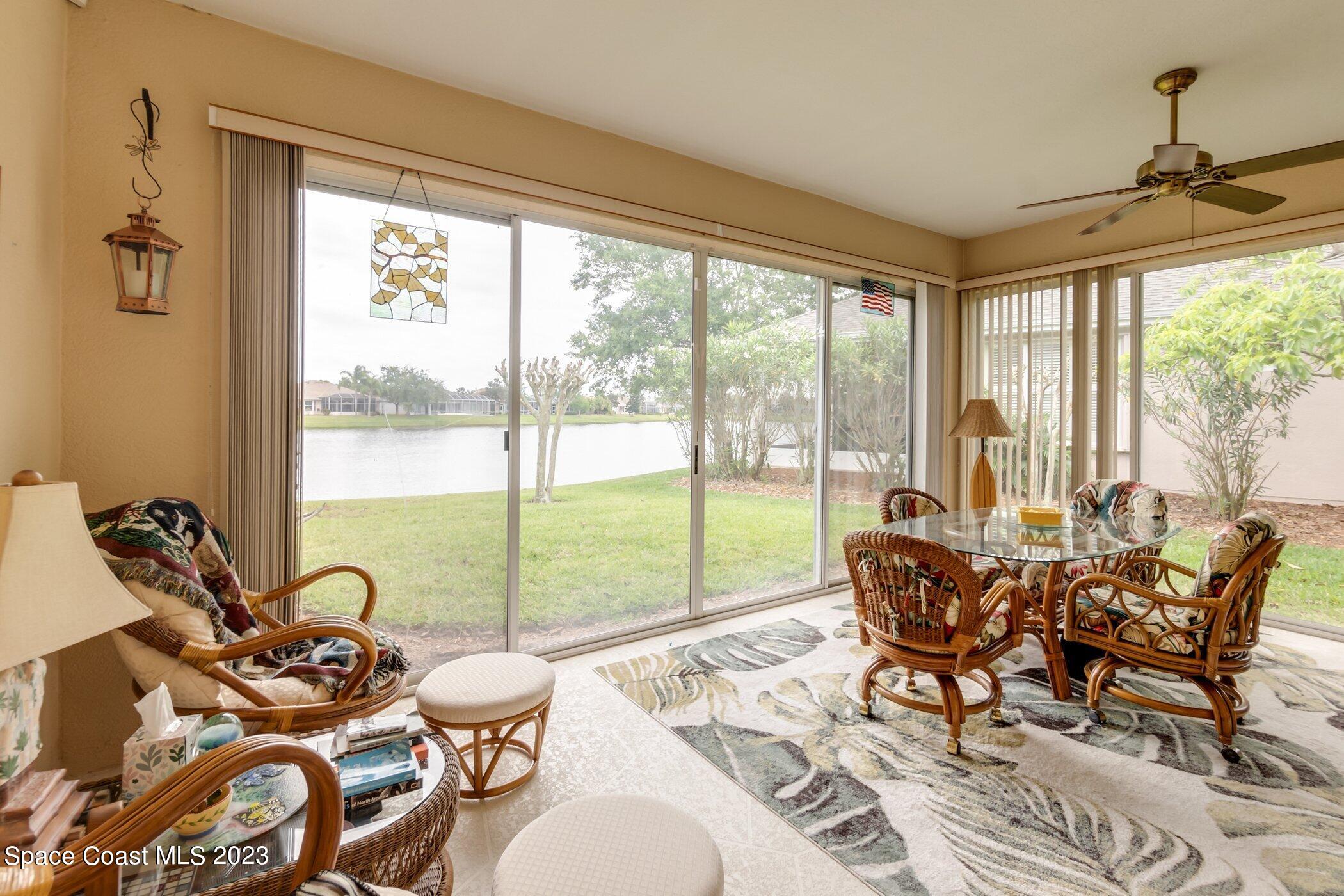 4370 Aberdeen Circle Rockledge, FL 32955 - Photo 4 of 58 a living room with furniture and floor to ceiling windows