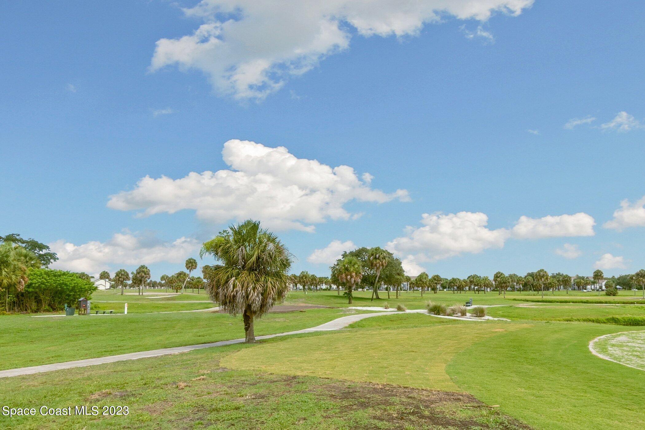 4370 Aberdeen Circle Rockledge, FL 32955 - Photo 52 of 58 a view of a golf course with a lake