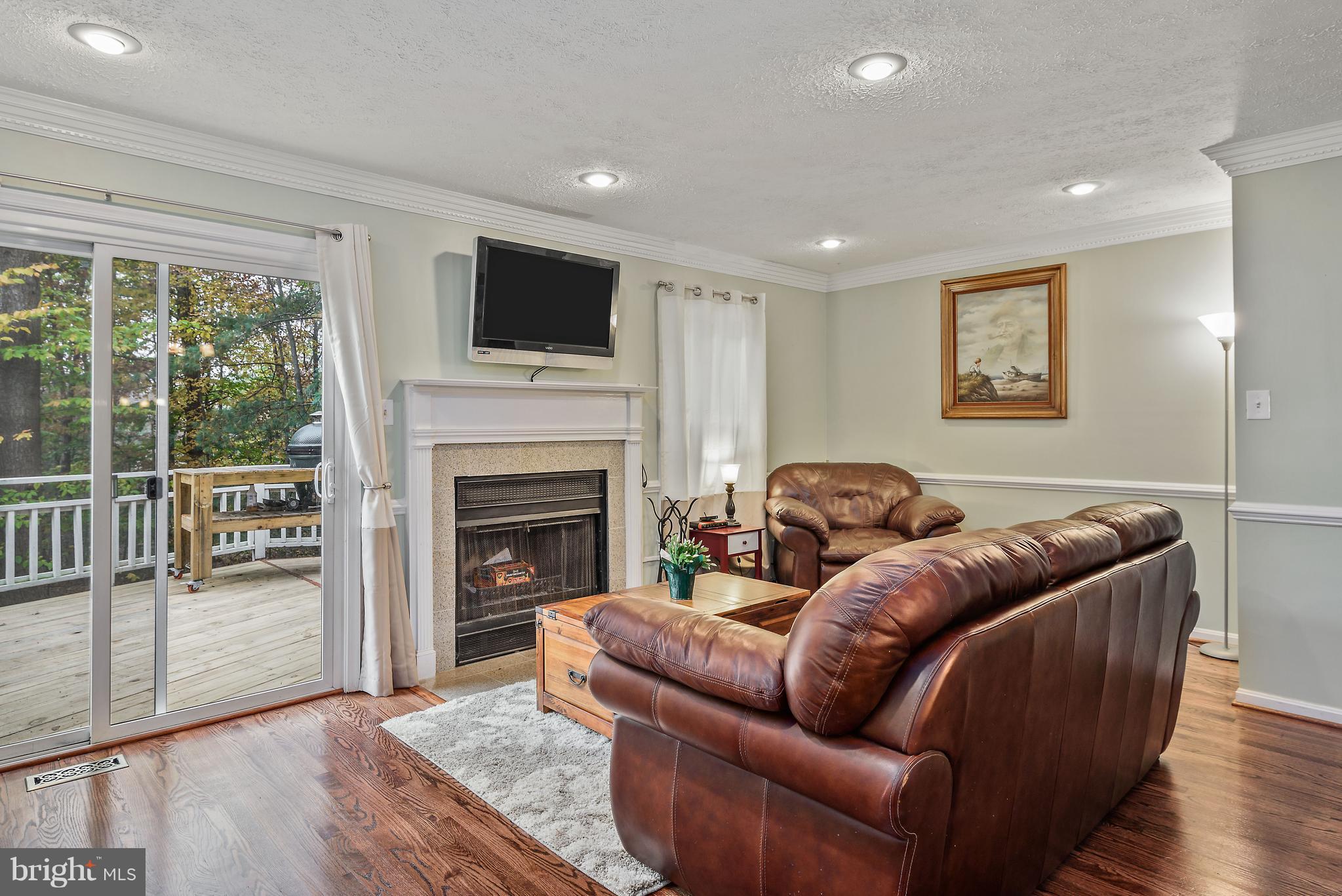 7305 Stream Way Springfield, VA 22152 - Photo 8 of 35 Living Room with Hardwood Flooring and Fireplace