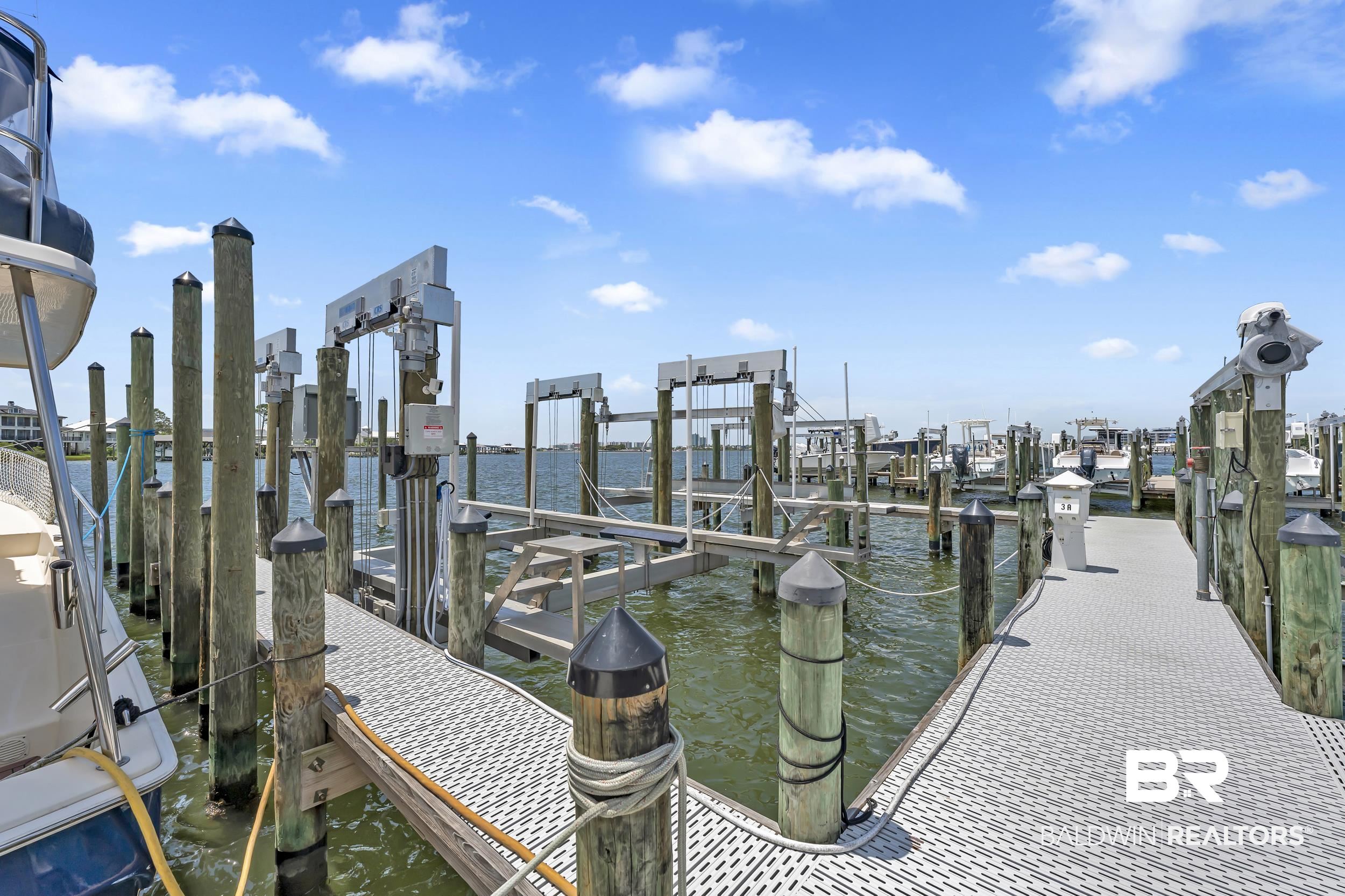 28250 Canal Road, Unit 307 Orange Beach, AL 36561 - Photo 13 of 56 Dock area featuring a water view and boat lift