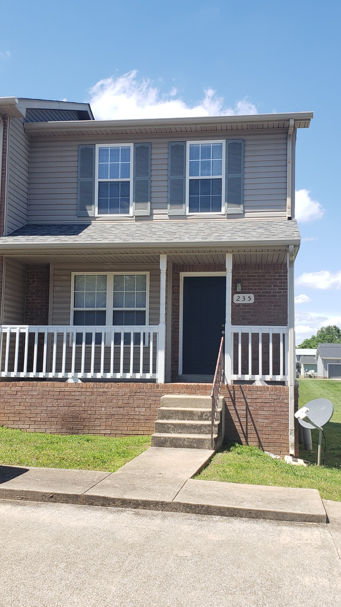 a view of a house next to a yard