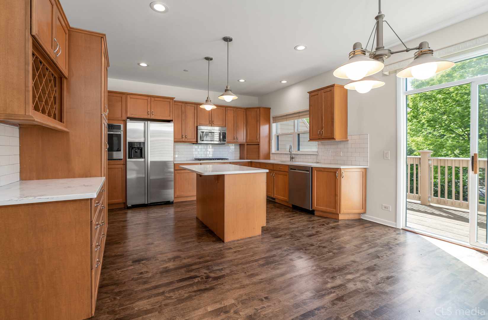 3540 Patten Road Highland Park, IL 60035 - Photo 7 of 30 a kitchen with stainless steel appliances granite countertop a refrigerator a sink dishwasher a oven and a dining table with wooden floor