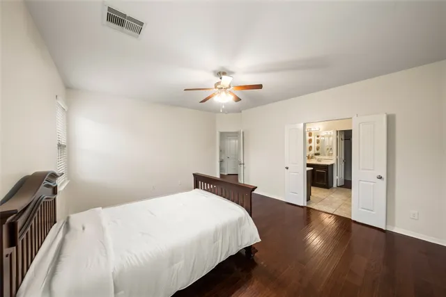 a bedroom with bed and a chandelier