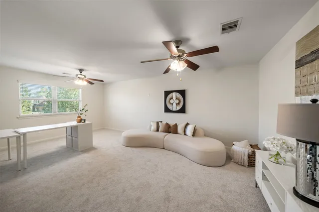 a spacious bedroom with a bed and a large window