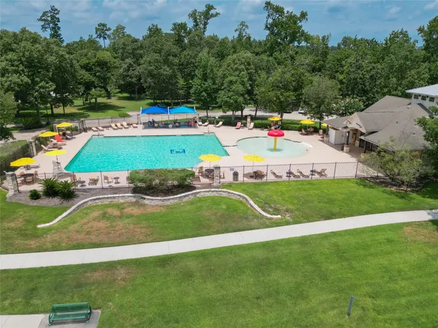 a small pool with lawn chairs and a big yard