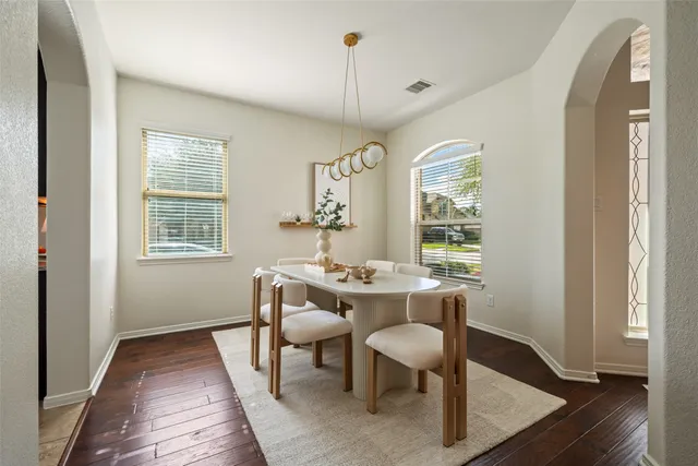 a view of a dining room with furniture window and wooden floor
