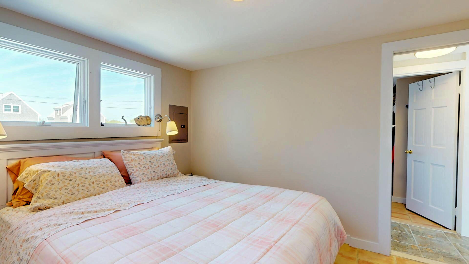 596 Shore Road, Unit H Truro, MA 02666 - Photo 21 of 30 a bedroom with a bed and window
