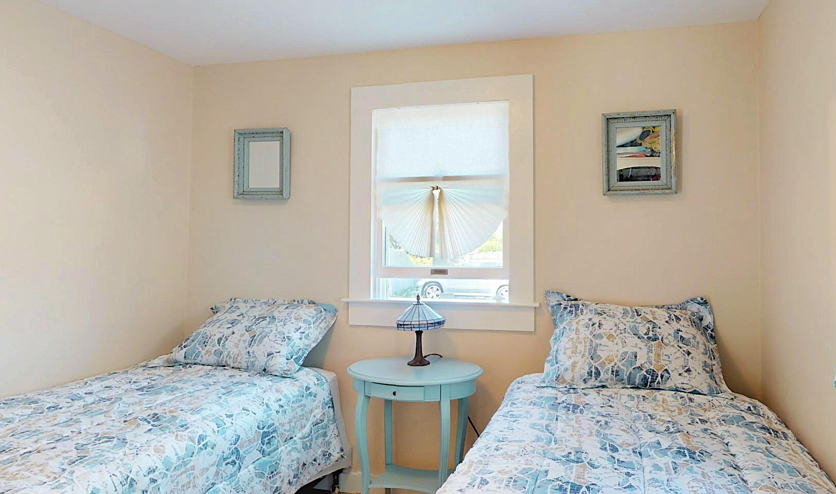 596 Shore Road, Unit H Truro, MA 02666 - Photo 24 of 30 a bedroom with a bed and a table