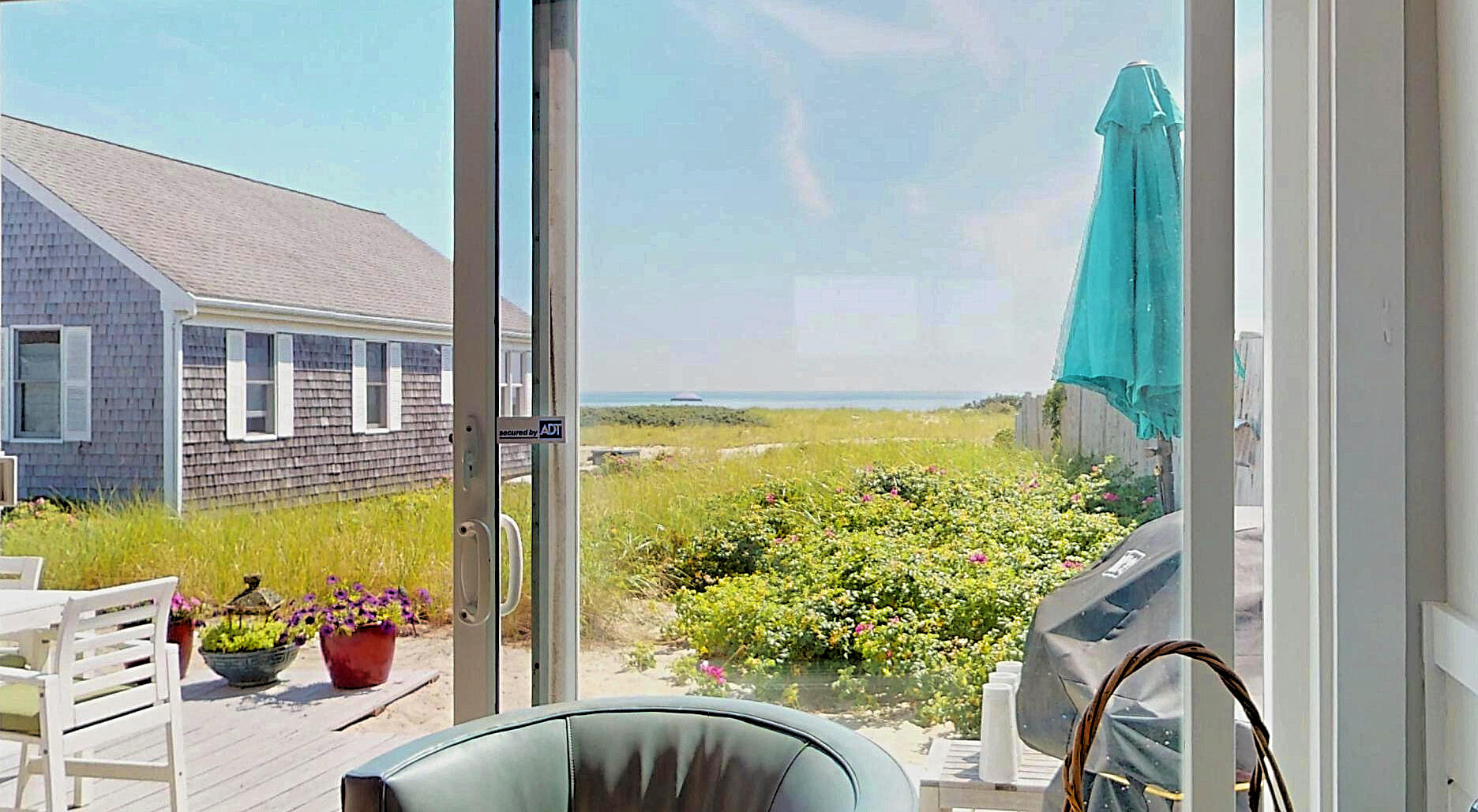 596 Shore Road, Unit H Truro, MA 02666 - Photo 6 of 30 a view of a balcony with chair and table