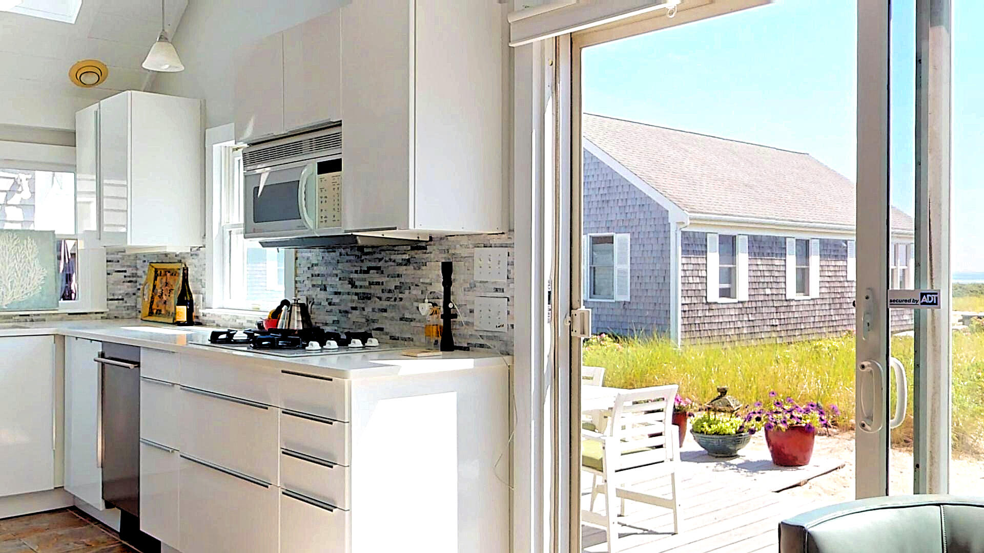 596 Shore Road, Unit H Truro, MA 02666 - Photo 7 of 30 a kitchen with a sink a stove and cabinets