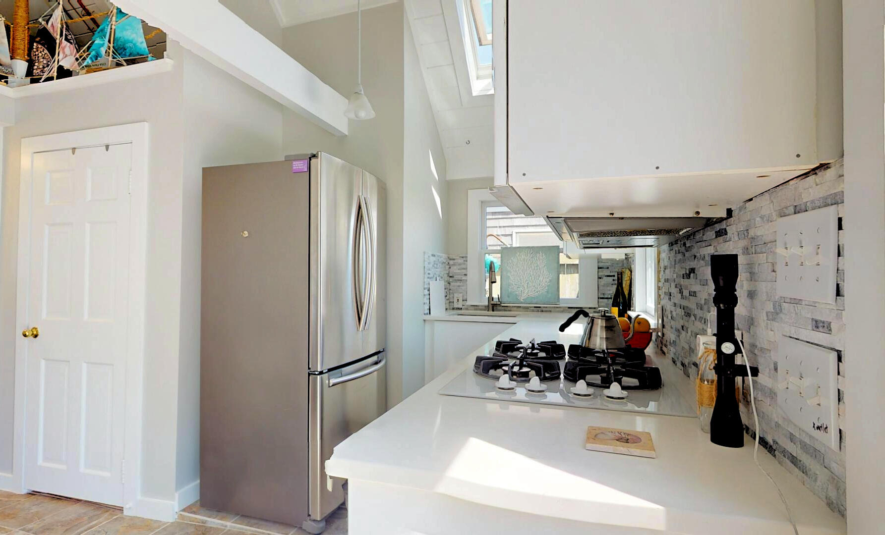 596 Shore Road, Unit H Truro, MA 02666 - Photo 9 of 30 a kitchen with stainless steel appliances a refrigerator and a sink