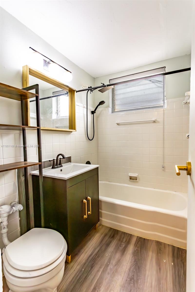 7720 Harding Avenue, Unit 3 Miami Beach, FL 33141 - Photo 5 of 15 a bathroom with a sink a toilet and shower