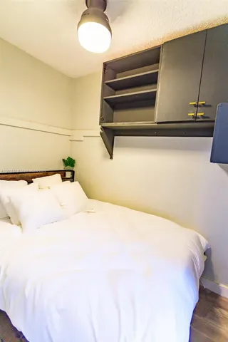 a kitchen with a sink a refrigerator and cabinets