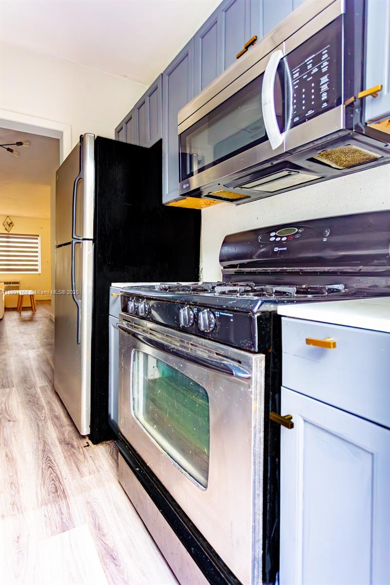 7720 Harding Avenue, Unit 3 Miami Beach, FL 33141 - Photo 8 of 15 a stove top oven sitting inside of a kitchen