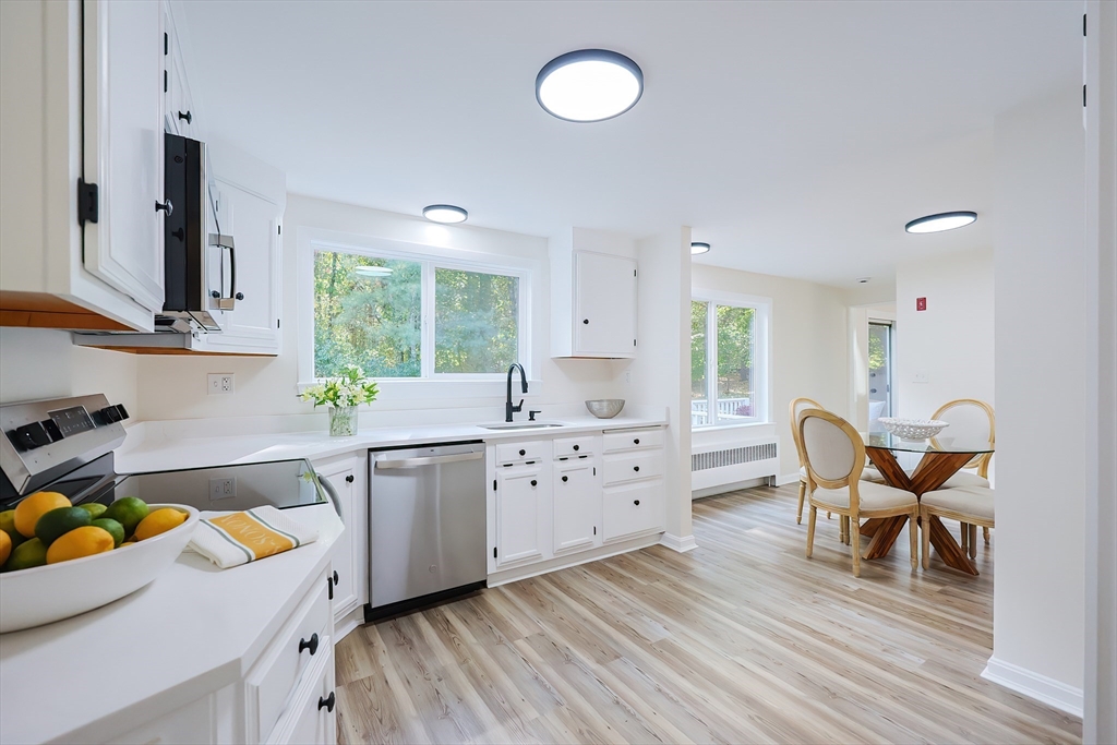 a kitchen with a wooden floor and white appliances