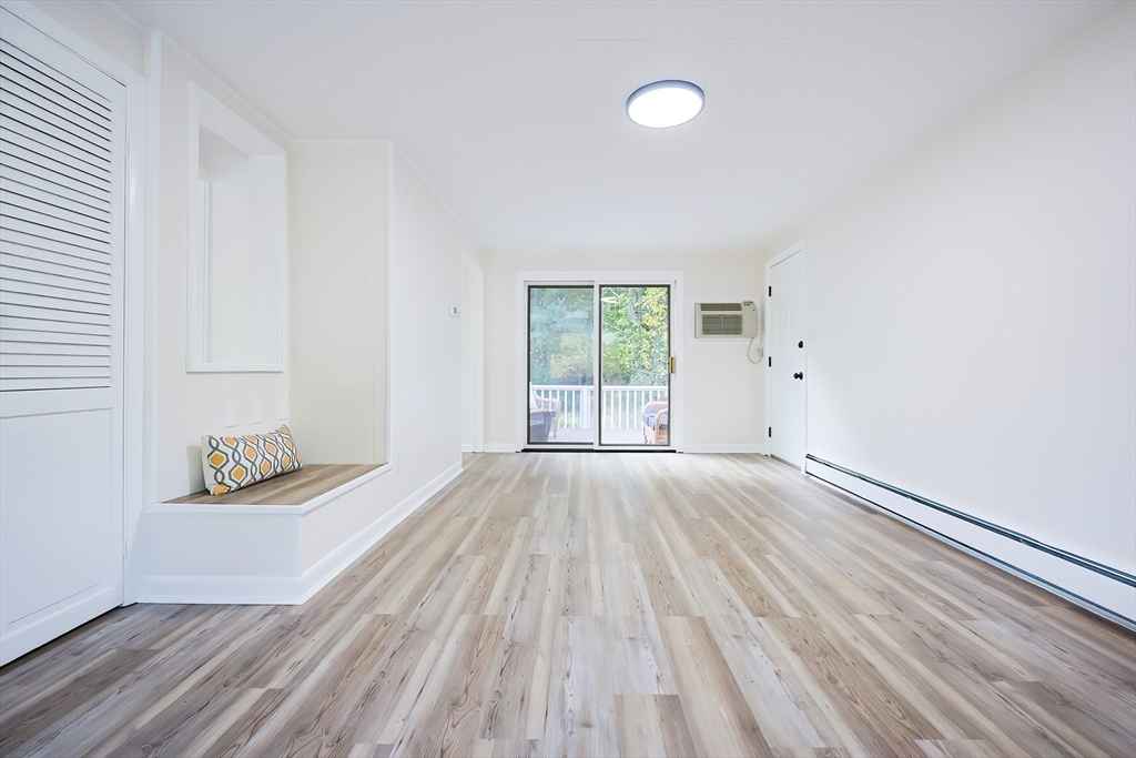 16 Deerfield Road Sharon, MA 02067 - Photo 12 of 38 an empty room with wooden floor and windows