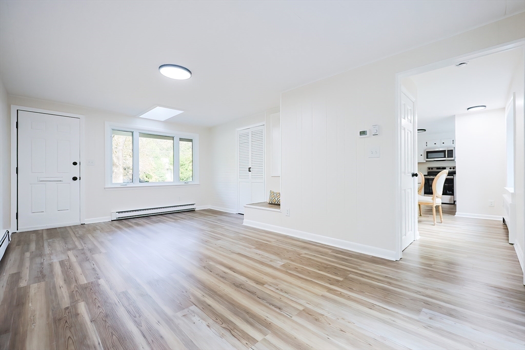 16 Deerfield Road Sharon, MA 02067 - Photo 13 of 38 an empty room with wooden floor and windows