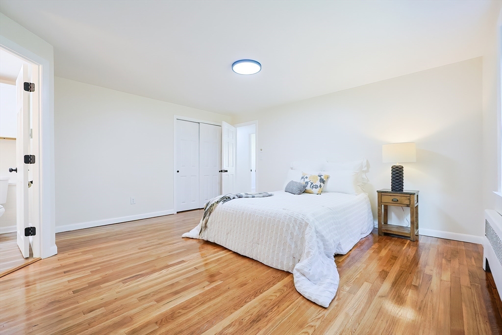 16 Deerfield Road Sharon, MA 02067 - Photo 14 of 38 a bedroom with a bed and wooden floor