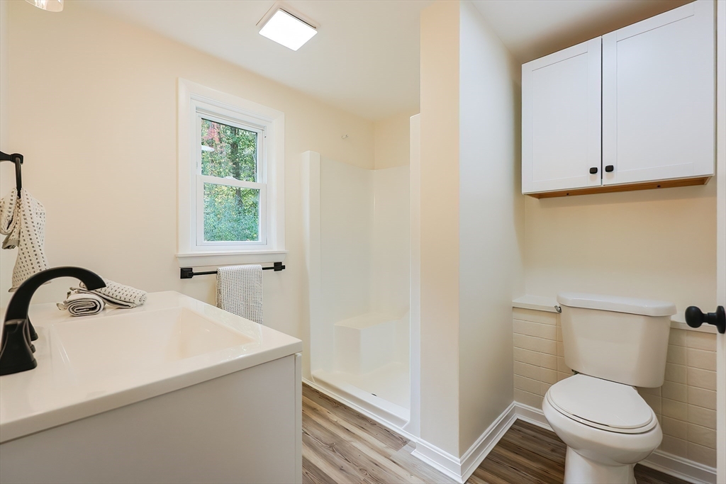 16 Deerfield Road Sharon, MA 02067 - Photo 16 of 38 a bathroom with a sink a toilet and a window