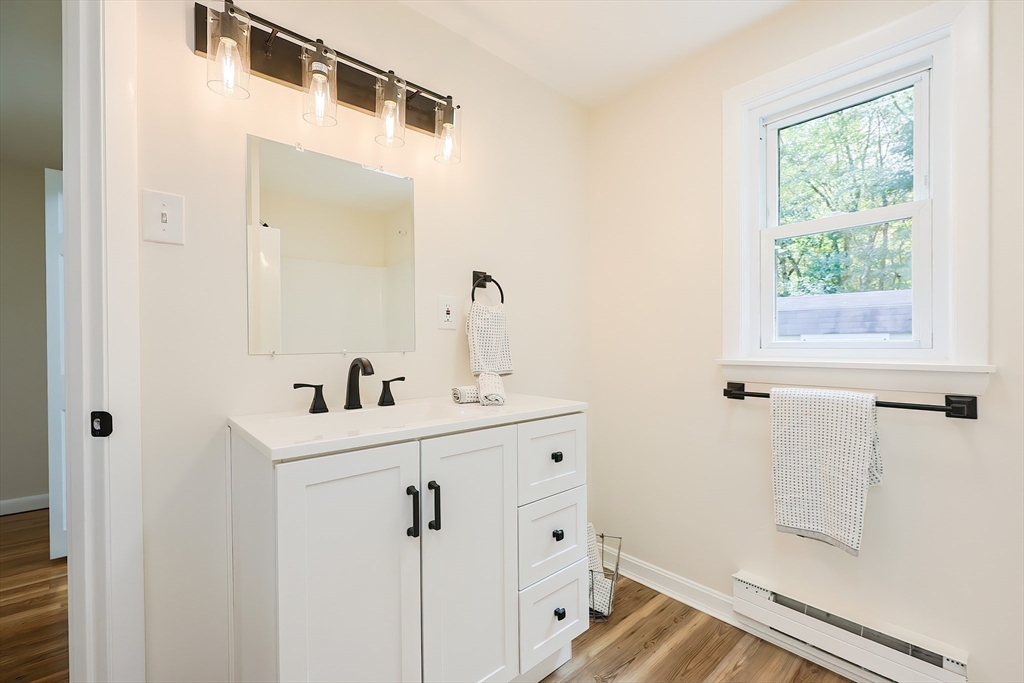 16 Deerfield Road Sharon, MA 02067 - Photo 17 of 38 a bathroom with a shower sink and mirror