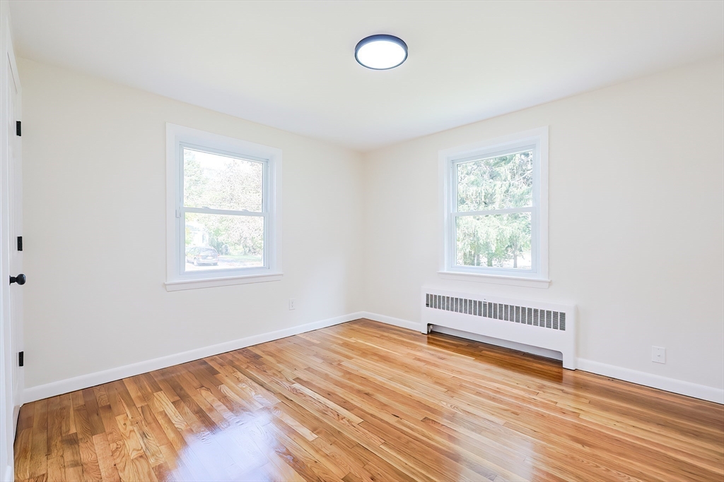 16 Deerfield Road Sharon, MA 02067 - Photo 18 of 38 an empty room with wooden floor and windows
