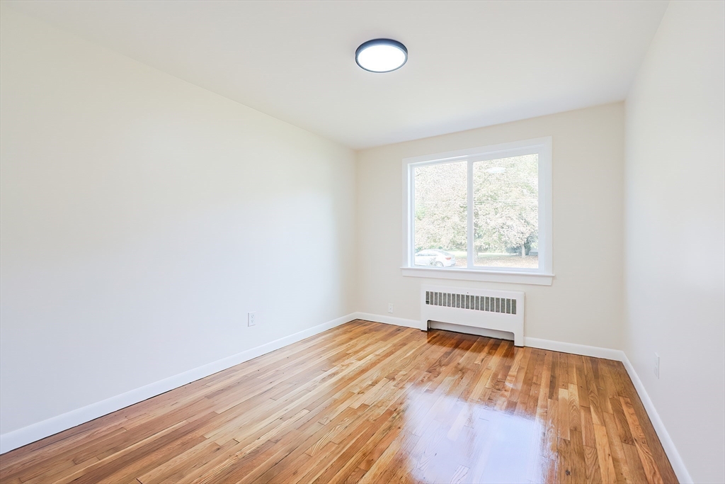 16 Deerfield Road Sharon, MA 02067 - Photo 19 of 38 an empty room with wooden floor and windows