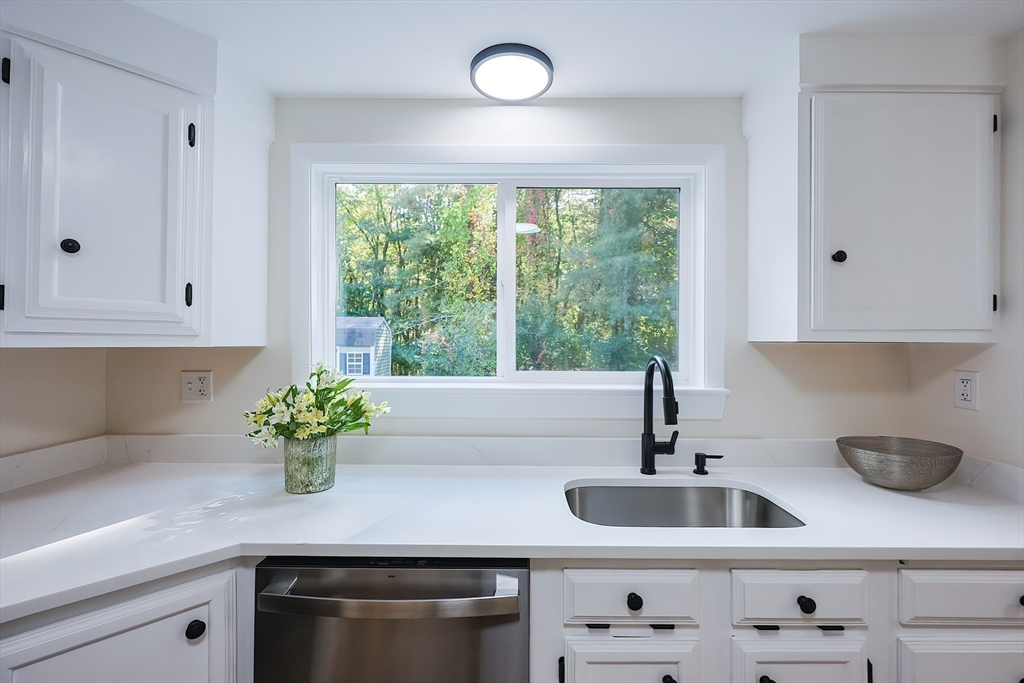 16 Deerfield Road Sharon, MA 02067 - Photo 5 of 38 a kitchen with stainless steel appliances white cabinets and a window