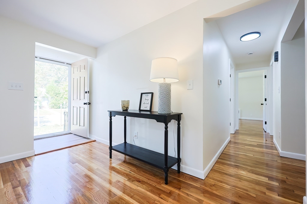 16 Deerfield Road Sharon, MA 02067 - Photo 10 of 38 a view of a hallway with wooden floor and staircase