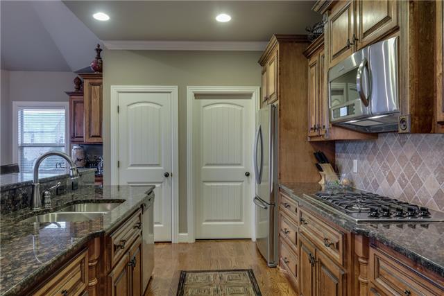 2070 Autumn Ridge Way Spring Hill, TN 37174 - Photo 13 of 20 Kitchen - gas cooktop; dishwasher; Built-in for your fridge; Built-in microwave. Pantry left; Utility room on right.
