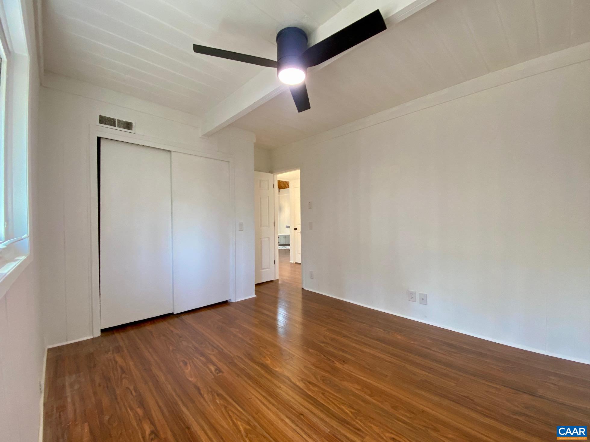24 Tanglewood Road Palmyra, VA 22963 - Photo 12 of 23 a view of an empty room with wooden floor and a ceiling fan