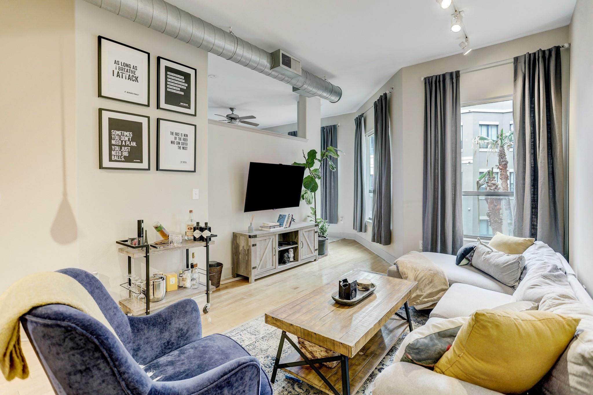 a living room with furniture and a flat screen tv