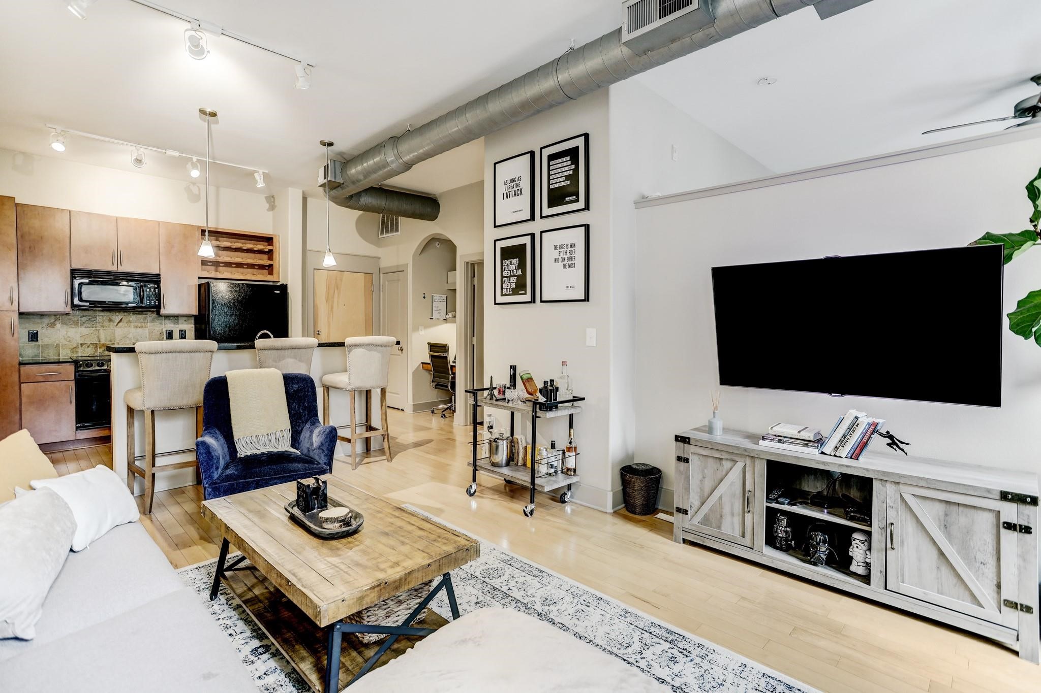 1901 Post Oak Boulevard, Unit 3502 Houston, TX 77056 - Photo 2 of 14 a living room with furniture and a flat screen tv