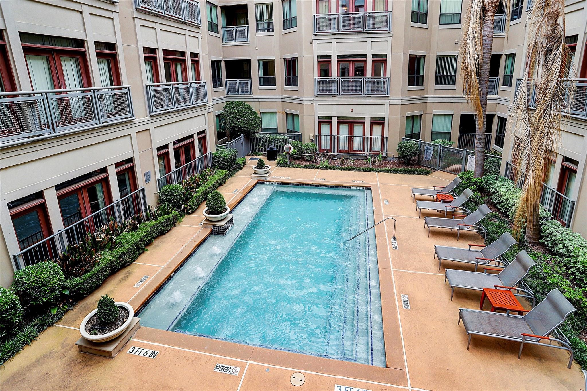 1901 Post Oak Boulevard, Unit 3502 Houston, TX 77056 - Photo 5 of 14 a view of swimming pool with a lounge chairs