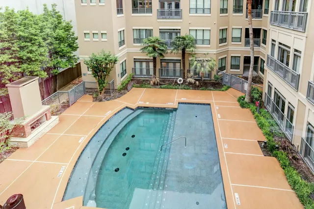 a view of swimming pool with a lounge chairs