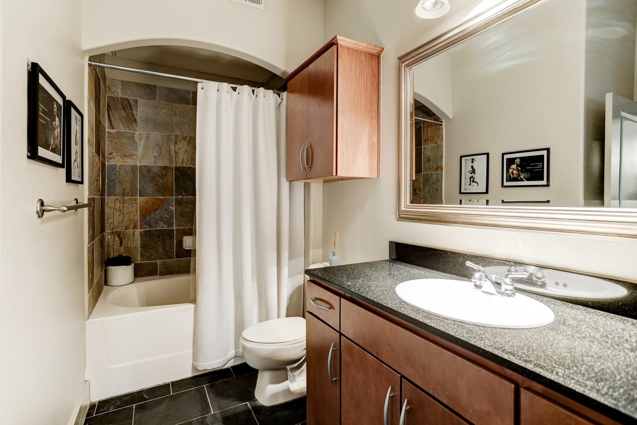 1901 Post Oak Boulevard, Unit 3502 Houston, TX 77056 - Photo 9 of 14 a bathroom with a granite countertop sink toilet and shower