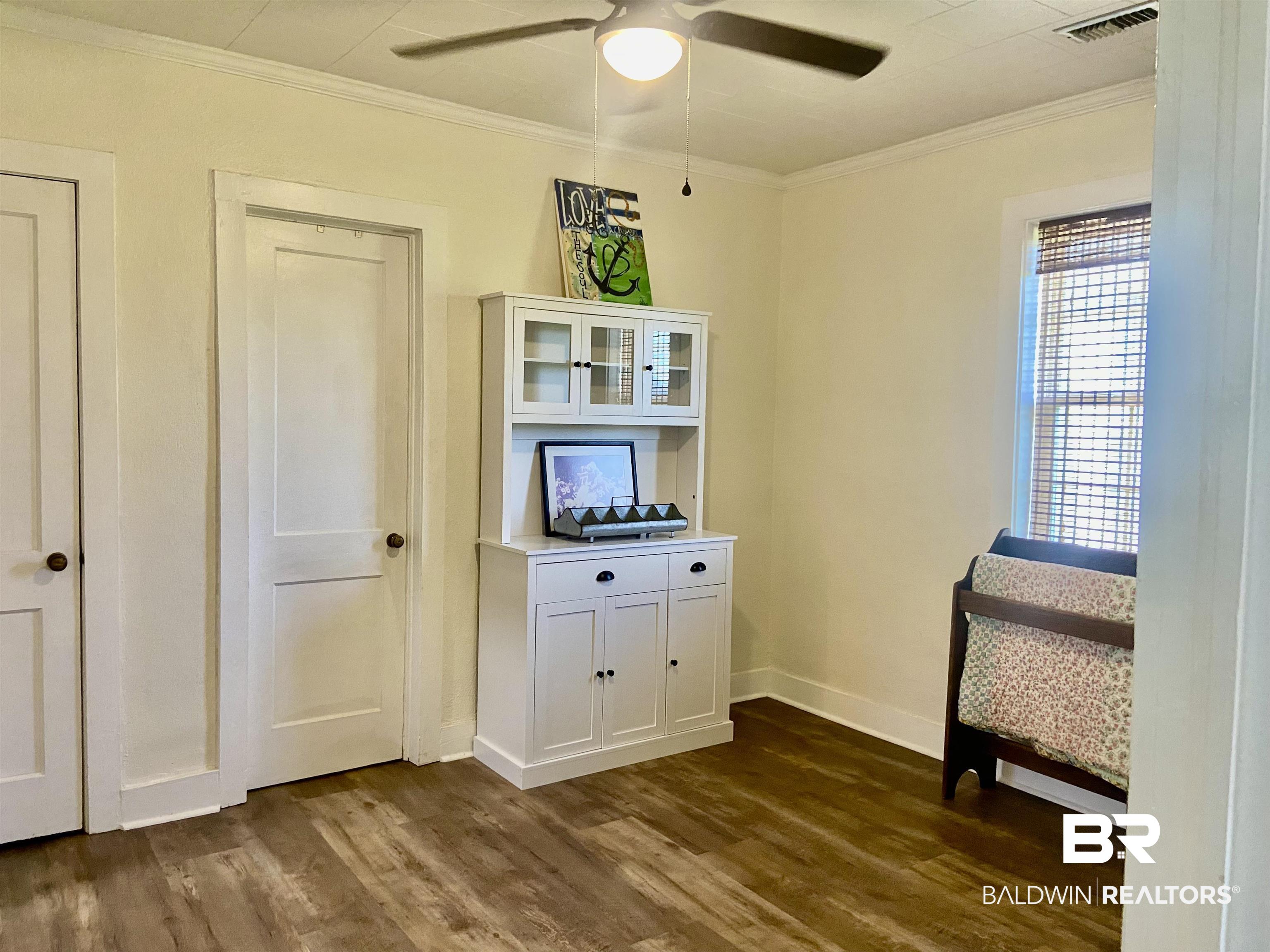 531 Highway 136 Monroeville, AL 36460 - Photo 33 of 48 Interior space with ceiling fan, dark hardwood / wood-style flooring, and ornamental molding