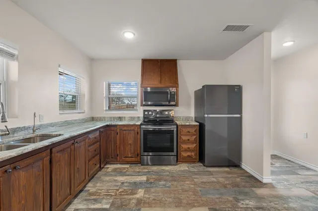 a bathroom with a granite countertop sink and mirror