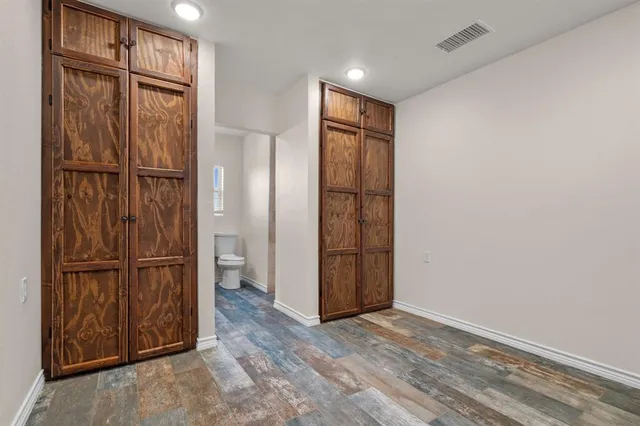 a bathroom with a granite countertop toilet a sink and a mirror